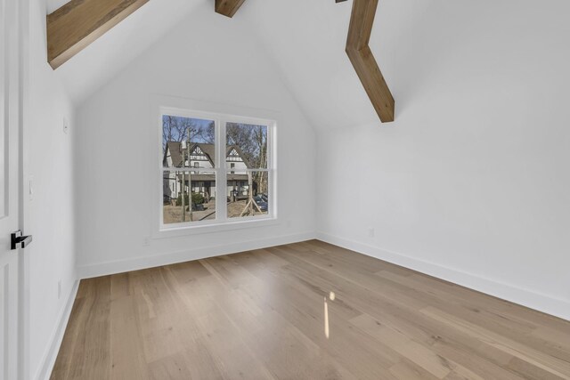 bonus room featuring lofted ceiling with beams and light hardwood / wood-style floors