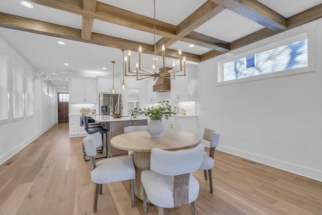 dining space with beamed ceiling, coffered ceiling, light hardwood / wood-style floors, and a notable chandelier