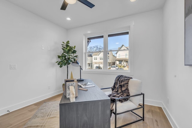 office with light hardwood / wood-style floors and ceiling fan