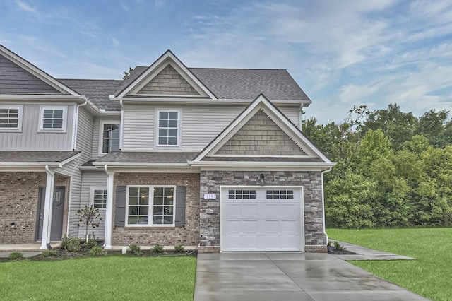 craftsman inspired home with a garage and a front lawn