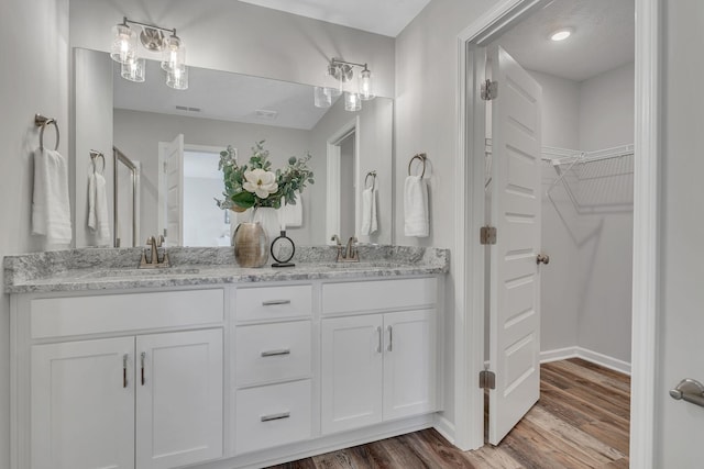 bathroom featuring vanity and wood-type flooring