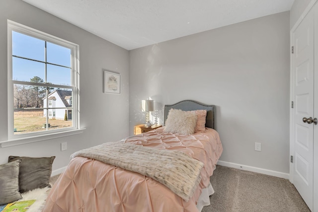 bedroom with carpet flooring and a textured ceiling