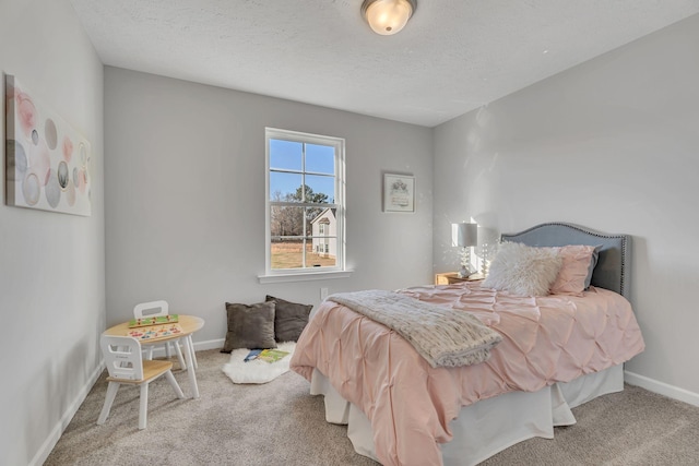 carpeted bedroom featuring a textured ceiling