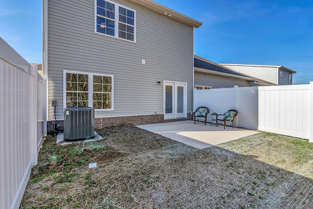 back of house featuring cooling unit and a patio