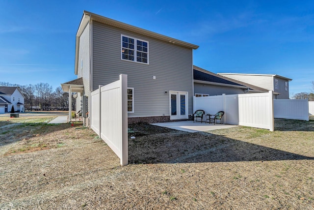 rear view of house featuring a patio area and french doors