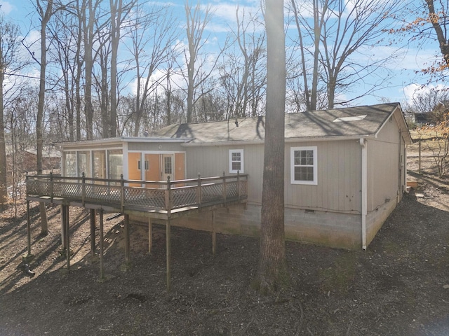 rear view of house featuring a deck