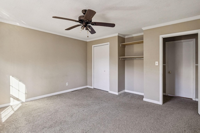 unfurnished bedroom featuring crown molding, carpet floors, a textured ceiling, and a closet