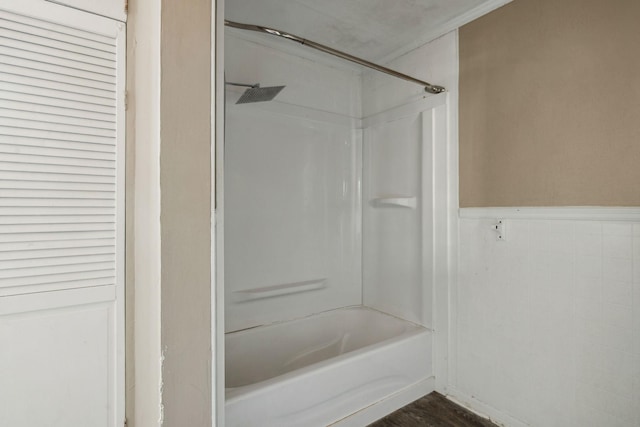 bathroom with wood-type flooring and shower / bathtub combination