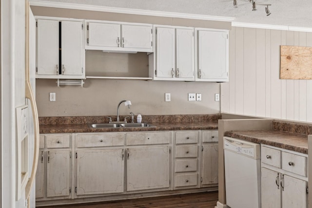 kitchen featuring sink, ornamental molding, dark hardwood / wood-style floors, dishwasher, and white cabinets