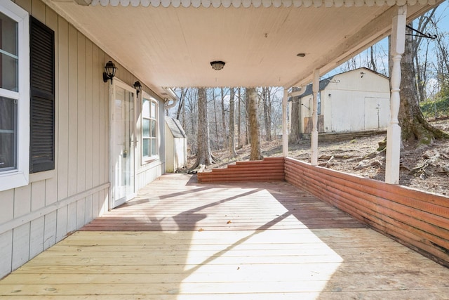 wooden terrace featuring a shed