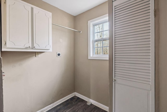 laundry room with cabinets, dark hardwood / wood-style floors, and electric dryer hookup