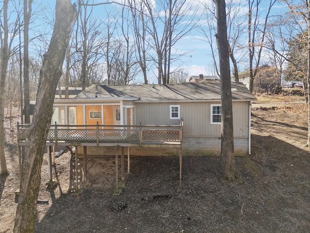 rear view of house featuring a deck