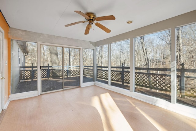 unfurnished sunroom with a healthy amount of sunlight and ceiling fan