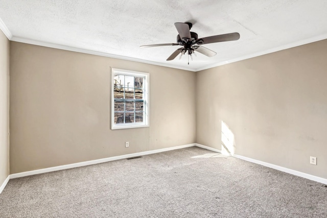 carpeted spare room featuring ornamental molding, ceiling fan, and a textured ceiling