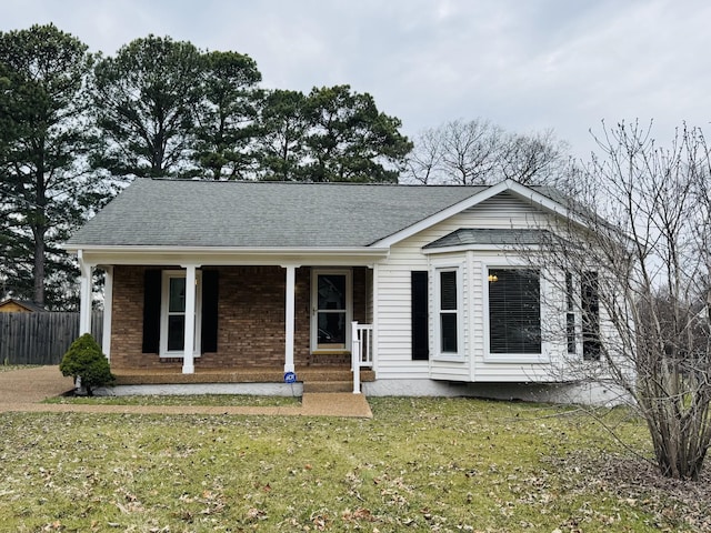 view of front of house with a porch and a front lawn