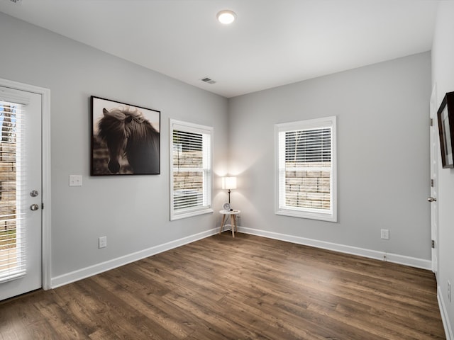 empty room with dark hardwood / wood-style floors