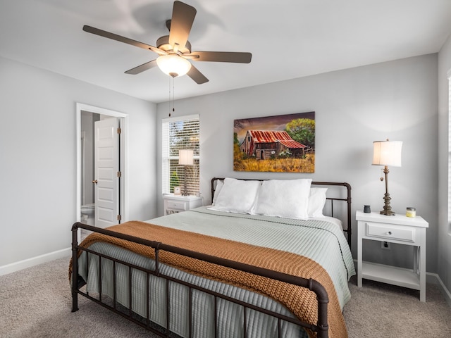 bedroom with ensuite bath, carpet floors, and ceiling fan