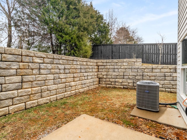 view of yard with cooling unit and a patio