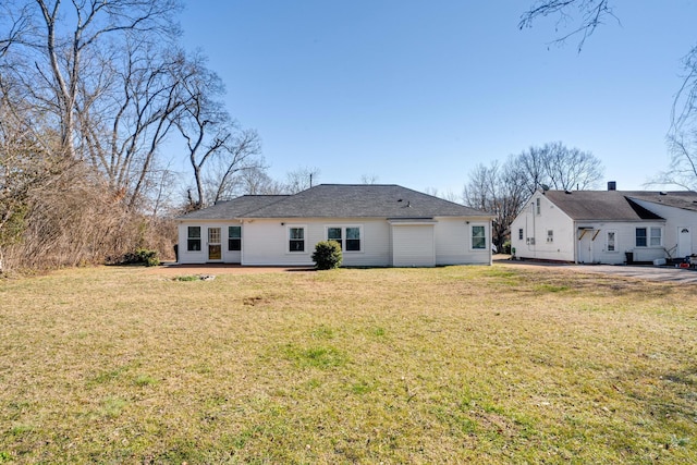 back of house featuring a lawn and a patio