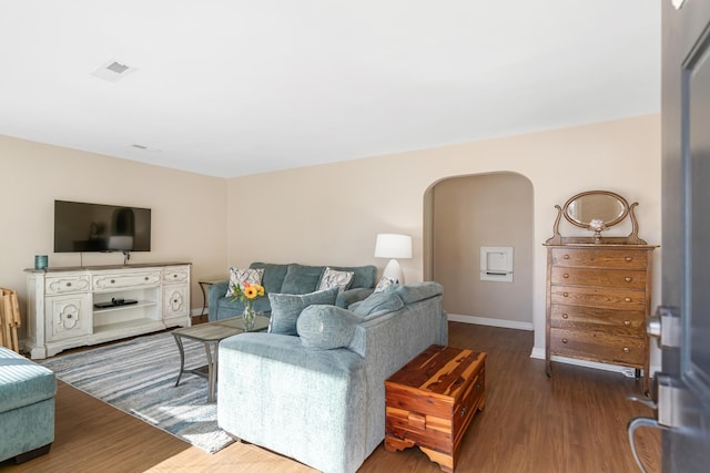 living room featuring dark wood-type flooring