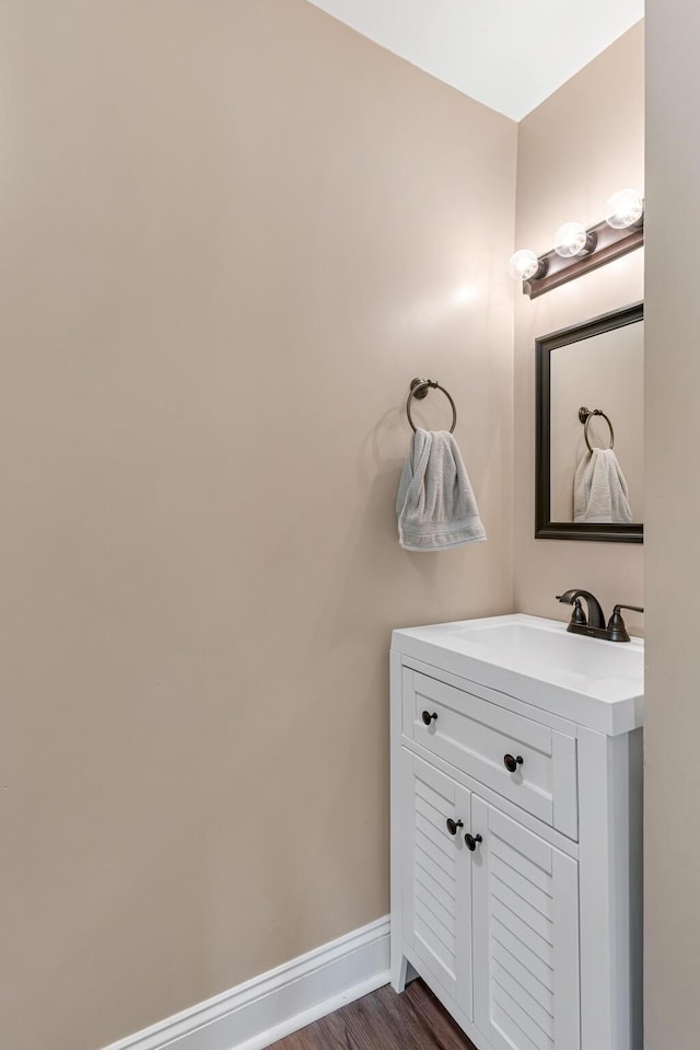 bathroom featuring hardwood / wood-style flooring and vanity