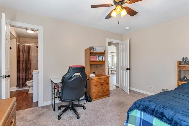 carpeted bedroom featuring connected bathroom and ceiling fan