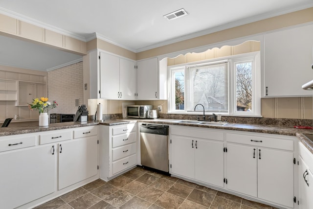 kitchen featuring sink, white cabinetry, crown molding, stainless steel appliances, and decorative backsplash