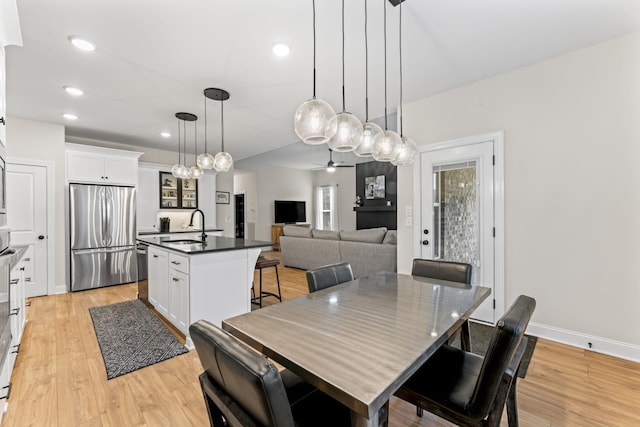 dining area with light hardwood / wood-style floors and sink