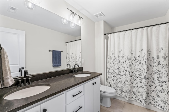 bathroom with vanity, tile patterned floors, and toilet