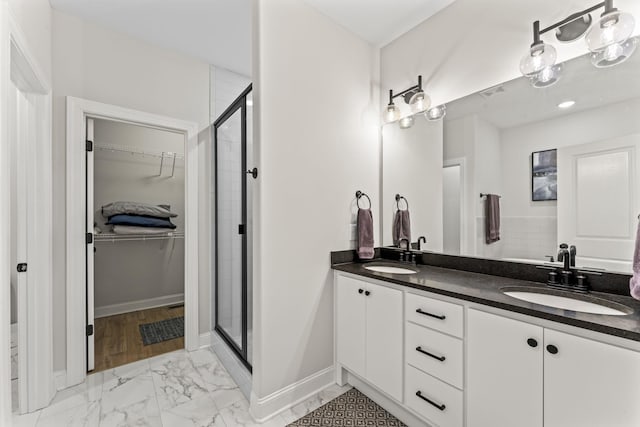 bathroom with vanity and a shower with shower door