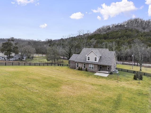 exterior space featuring a lawn and a rural view