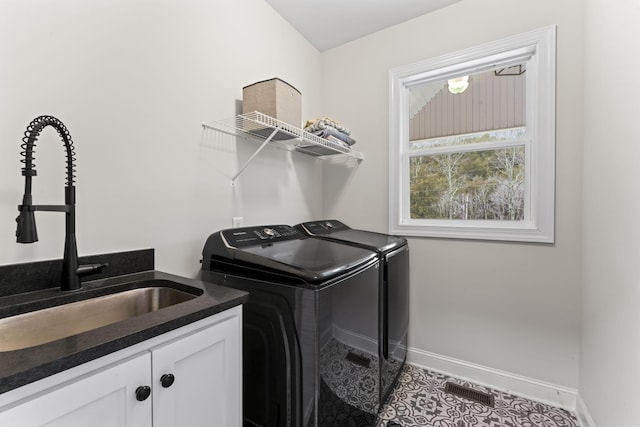 washroom featuring cabinets, independent washer and dryer, tile patterned floors, and sink