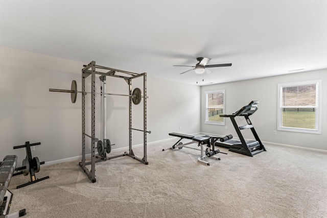 workout area featuring ceiling fan and light colored carpet