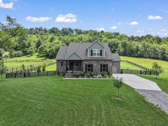 4612 Gossburg Rd, Beechgrove, TN 37018 - view of front facade featuring driveway, a view of countryside, and stone siding