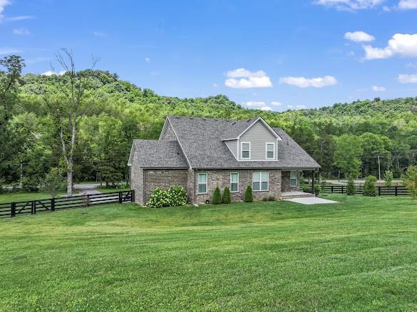 4612 Gossburg Rd, Beechgrove, TN 37018 - view of front of home featuring a patio area, a wooded view, and brick siding