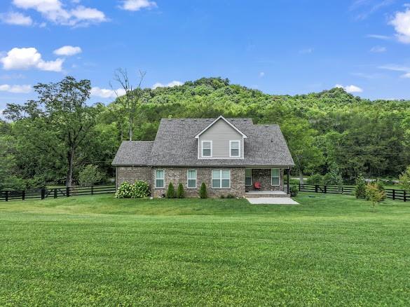 4612 Gossburg Rd, Beechgrove, TN 37018 - cape cod-style house with a forest view and a patio area