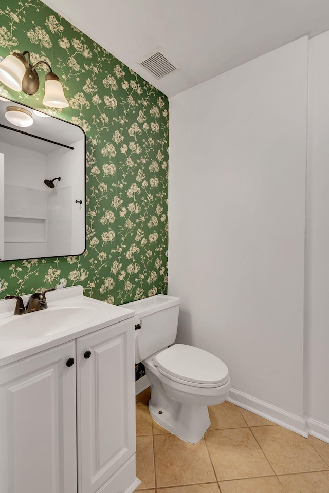 bathroom featuring vanity, tile patterned floors, and toilet