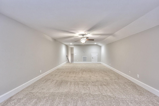 spare room featuring light carpet and ceiling fan