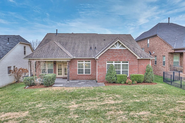 rear view of house with a yard and a patio area