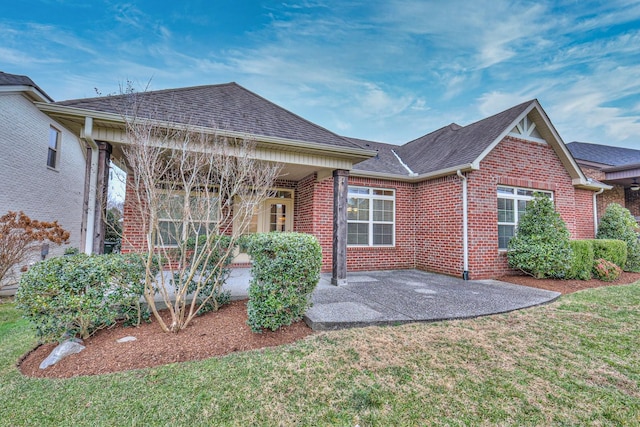 rear view of house featuring a lawn and a patio area