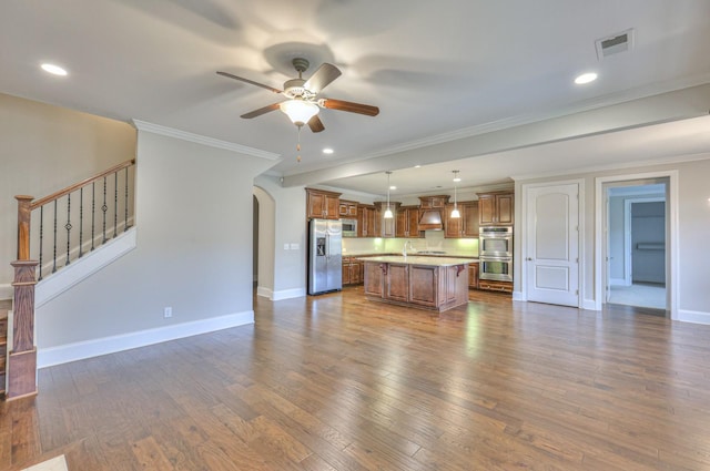 kitchen with a kitchen island, dark hardwood / wood-style floors, hanging light fixtures, ceiling fan, and stainless steel appliances