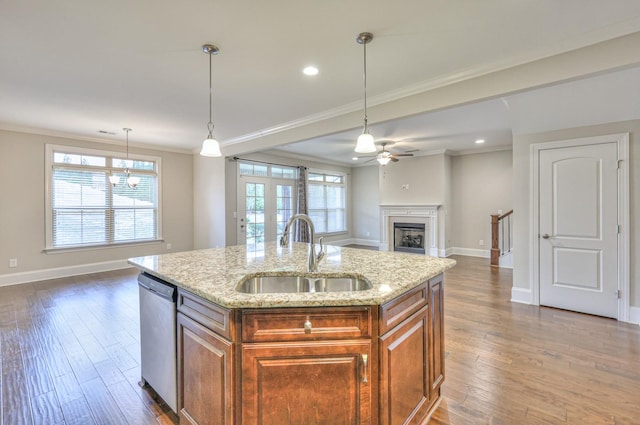 kitchen featuring sink, dark hardwood / wood-style flooring, a kitchen island with sink, stainless steel dishwasher, and light stone counters