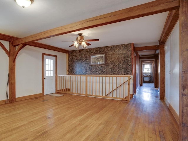 entryway with light wood-style flooring, baseboards, beam ceiling, and ceiling fan