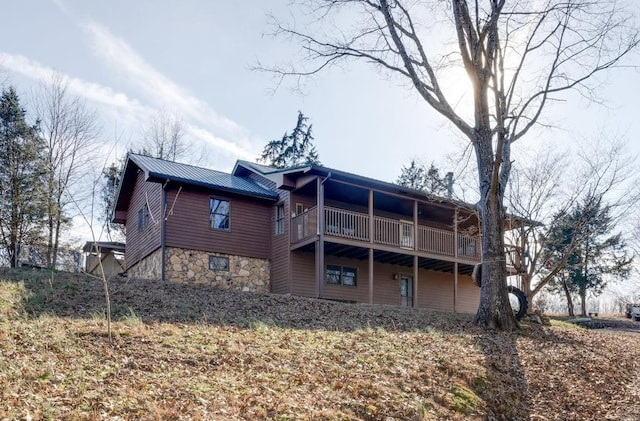 back of property featuring a balcony