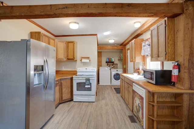 kitchen featuring separate washer and dryer, light countertops, stainless steel appliances, light wood finished floors, and a sink