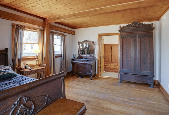bedroom with light wood-style floors, crown molding, connected bathroom, wooden ceiling, and baseboards