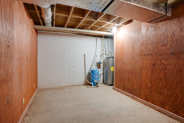 unfinished below grade area with concrete block wall and water heater