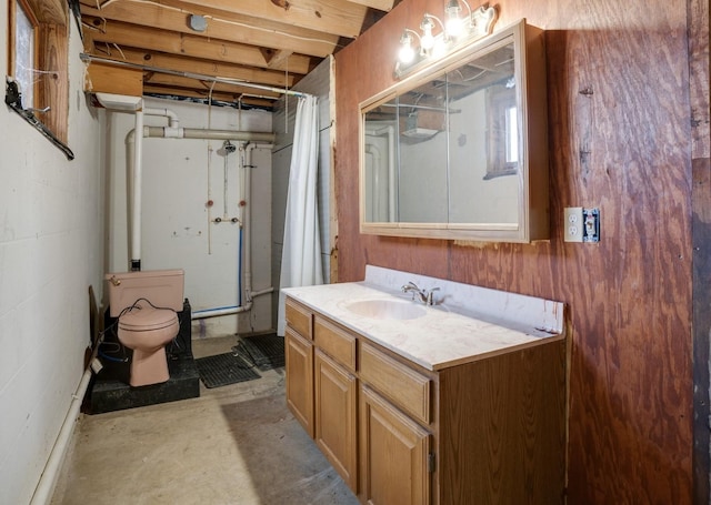 bathroom featuring toilet, curtained shower, concrete flooring, and vanity