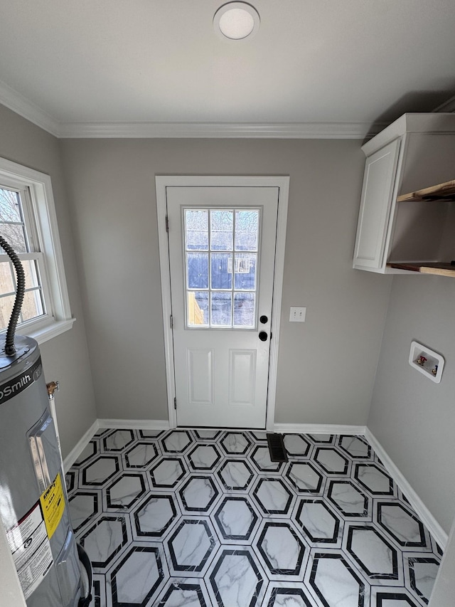 clothes washing area featuring crown molding, electric water heater, hookup for a washing machine, and cabinets