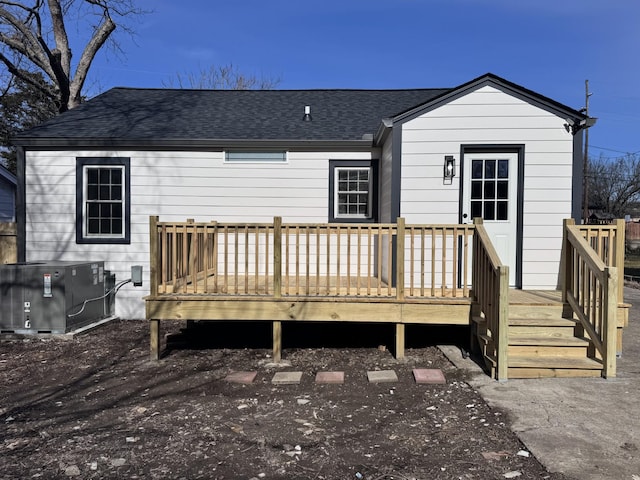 rear view of property with cooling unit and a wooden deck